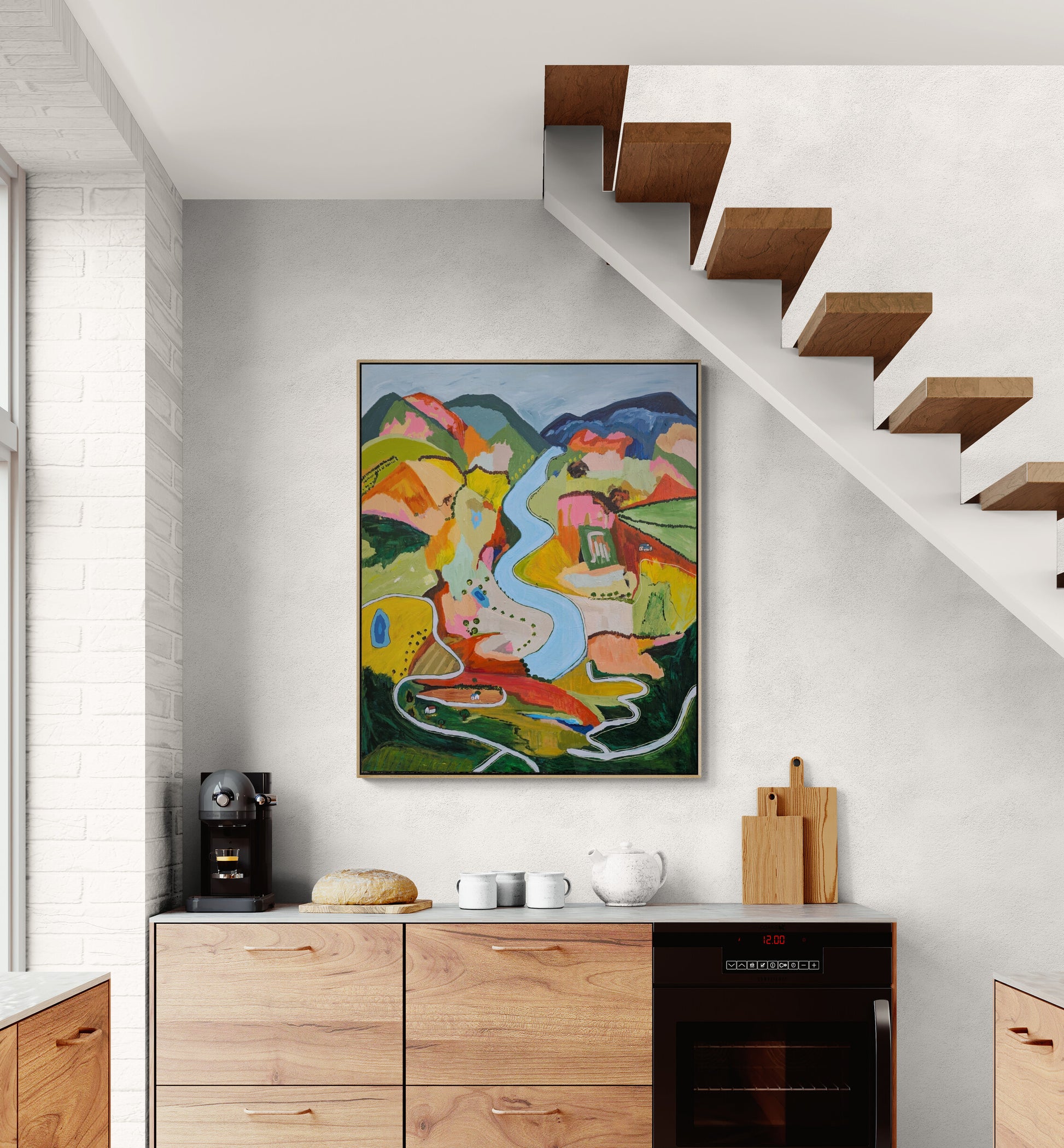  Colorful abstract painting By Alpana Rai on a wall above a kitchen counter with wooden cabinets.